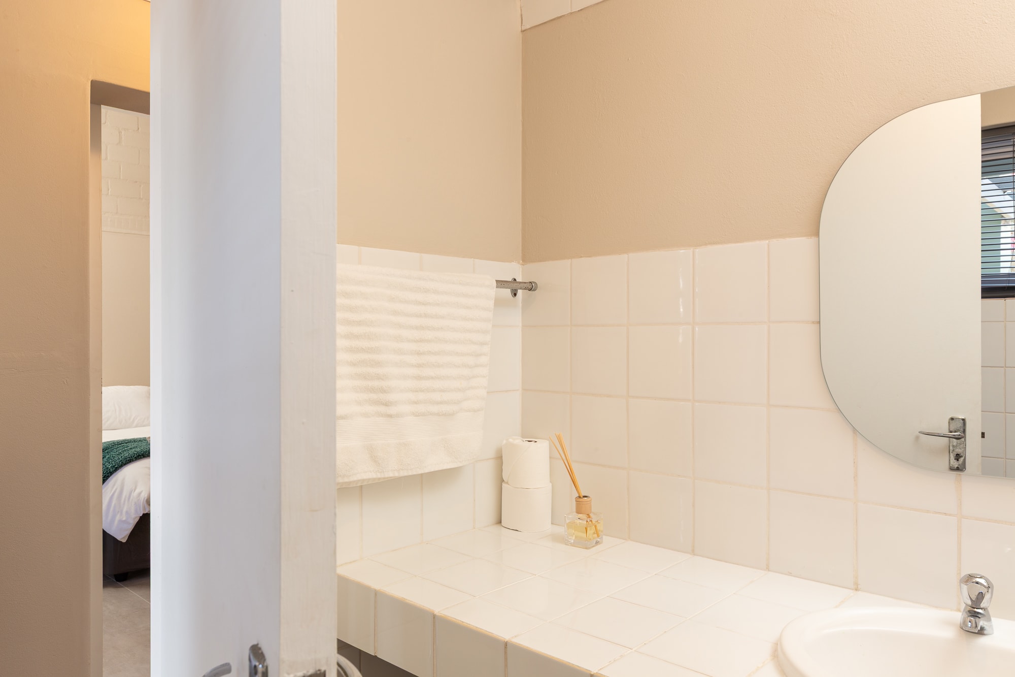 Modern bathroom with cream tile walls