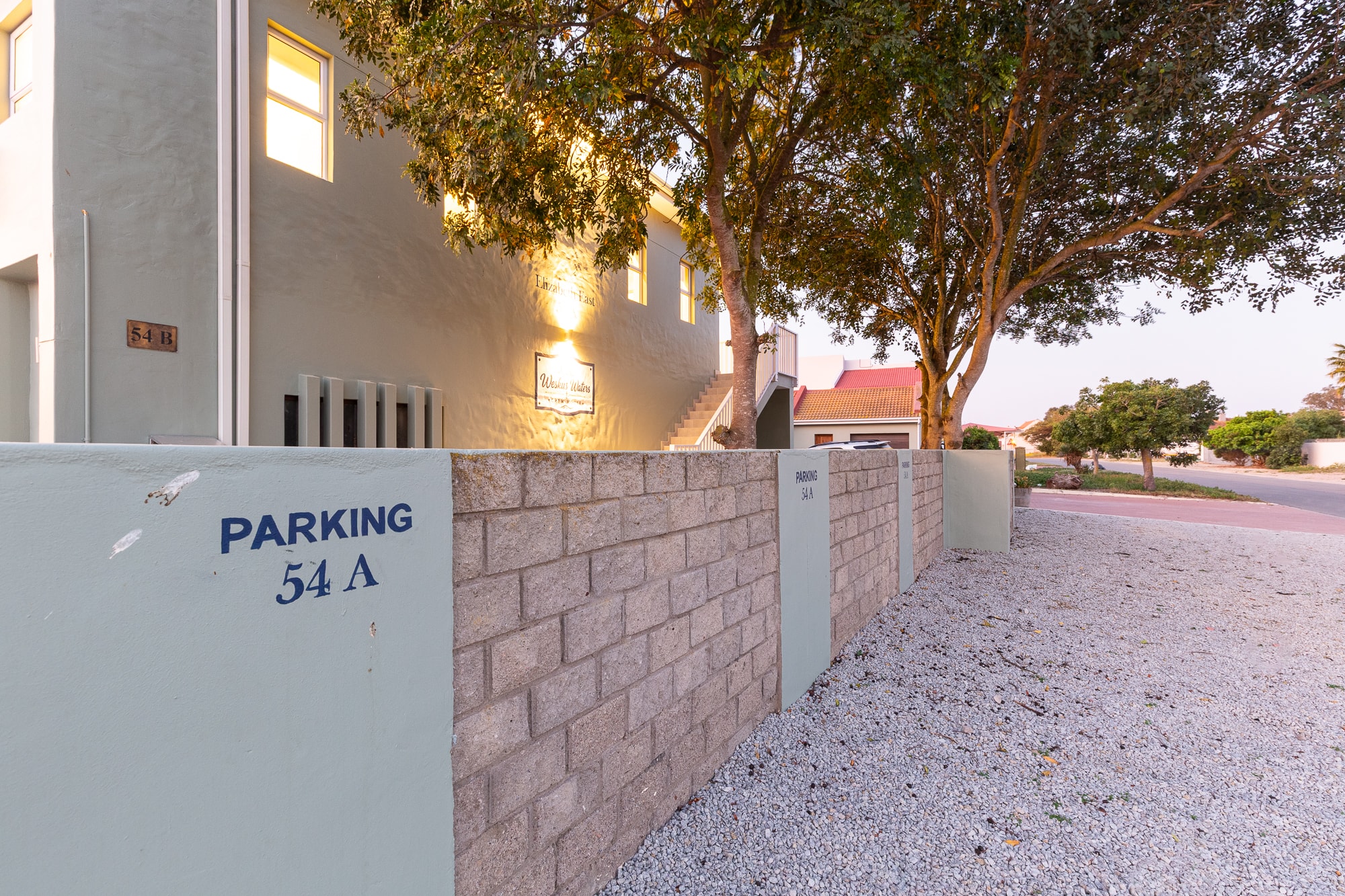 Residential parking area with brick wall entrance