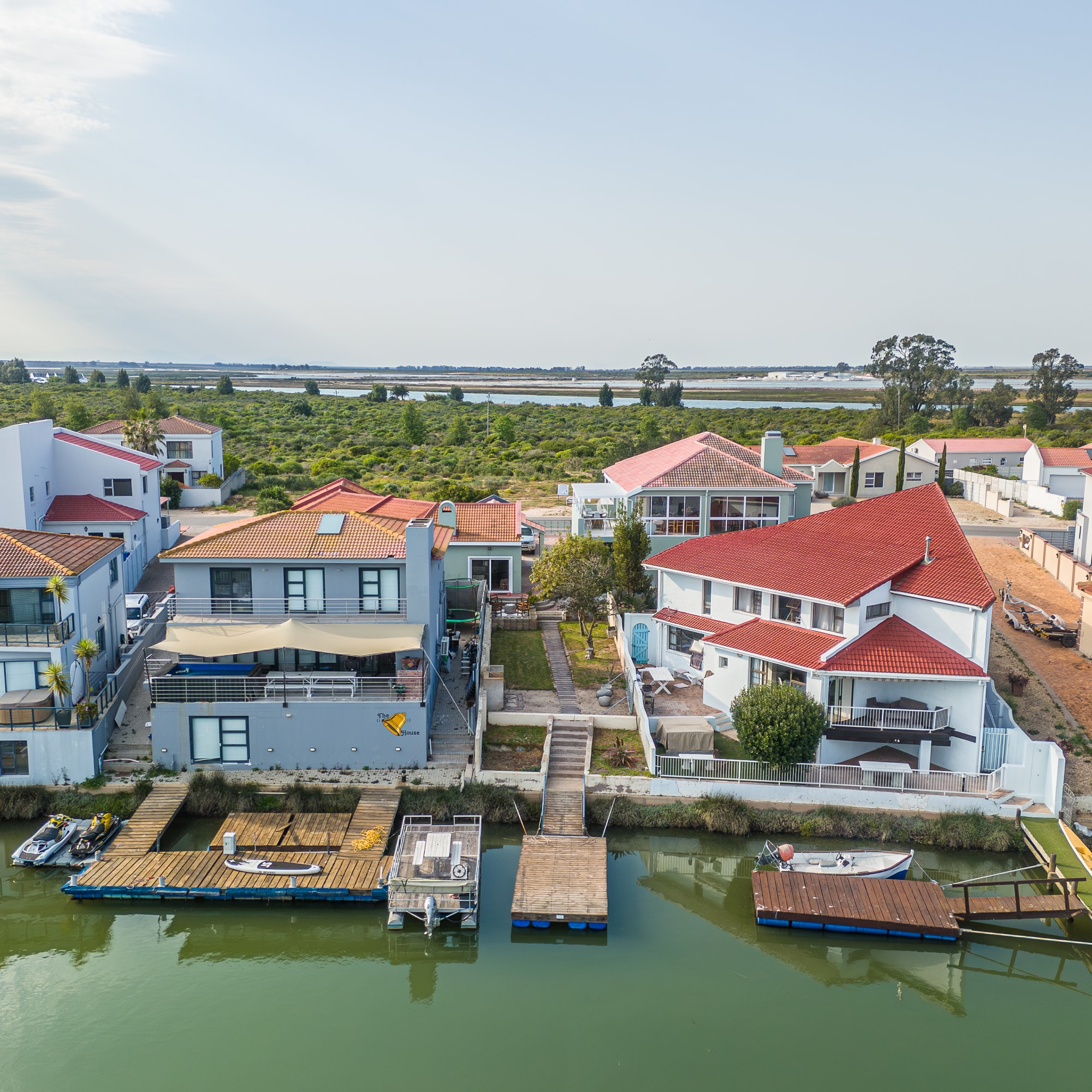 Waterfront homes with red tile roofs